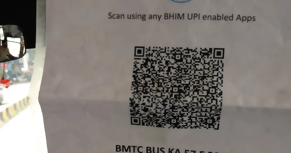 QR code displayed on a laptop screen with a smartphone scanning it